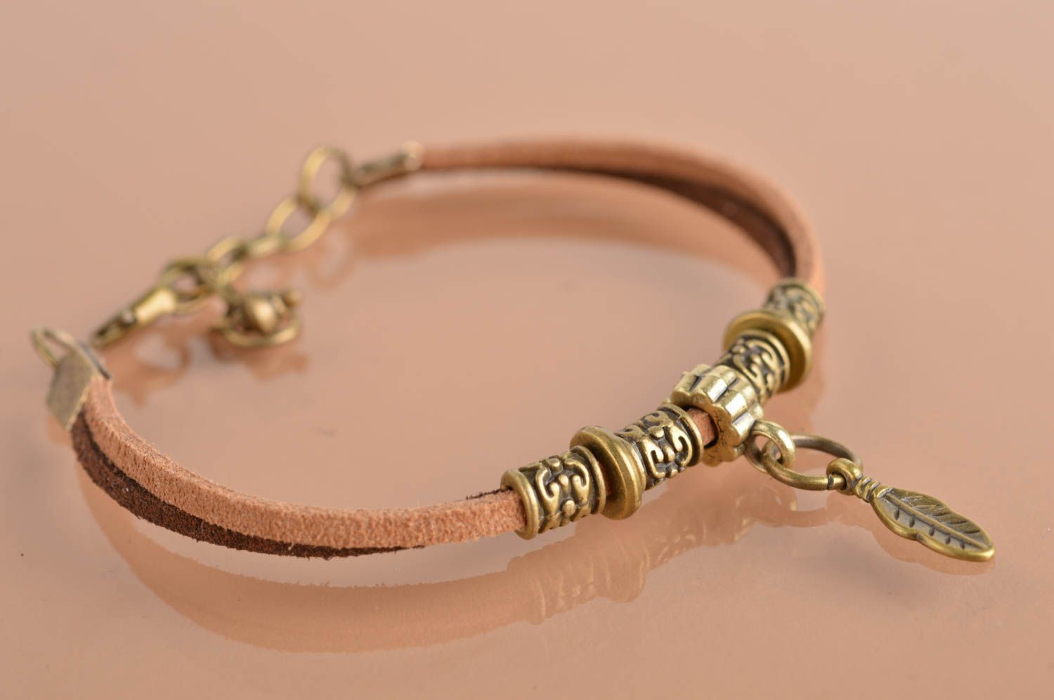 Handmade designer thin bracelet made of chamois leather lace with goldish charms photo 5