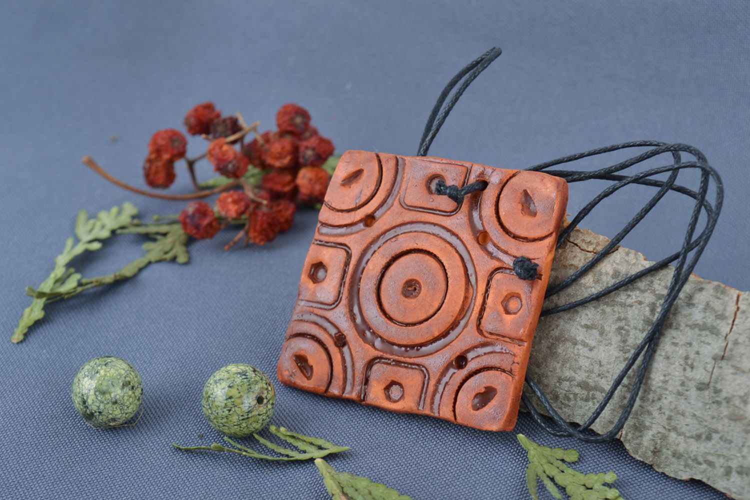 Handmade ceramic neck pendant of square shape with ornament in ethnic style photo 1