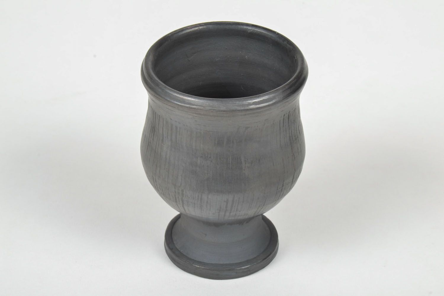 Wine goblet in black color on the stand without a handle. Great natural clay gift. photo 3