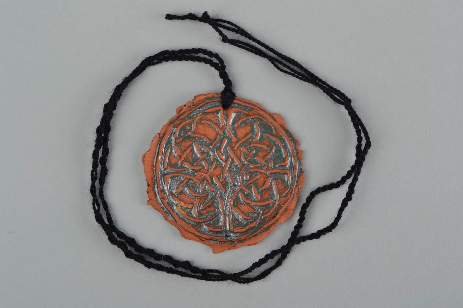 Handmade women's designer ceramic round pendant with relief ornament on cord photo 3