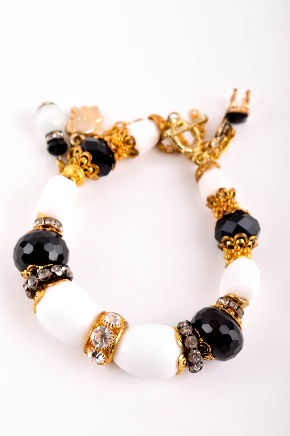 Handmade gemstone beaded bracelet with black and white beads and gold color charms for girls photo 2