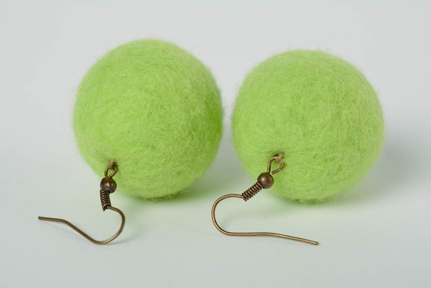 Handmade ball shaped dangling earrings felted of wool of light green color photo 4