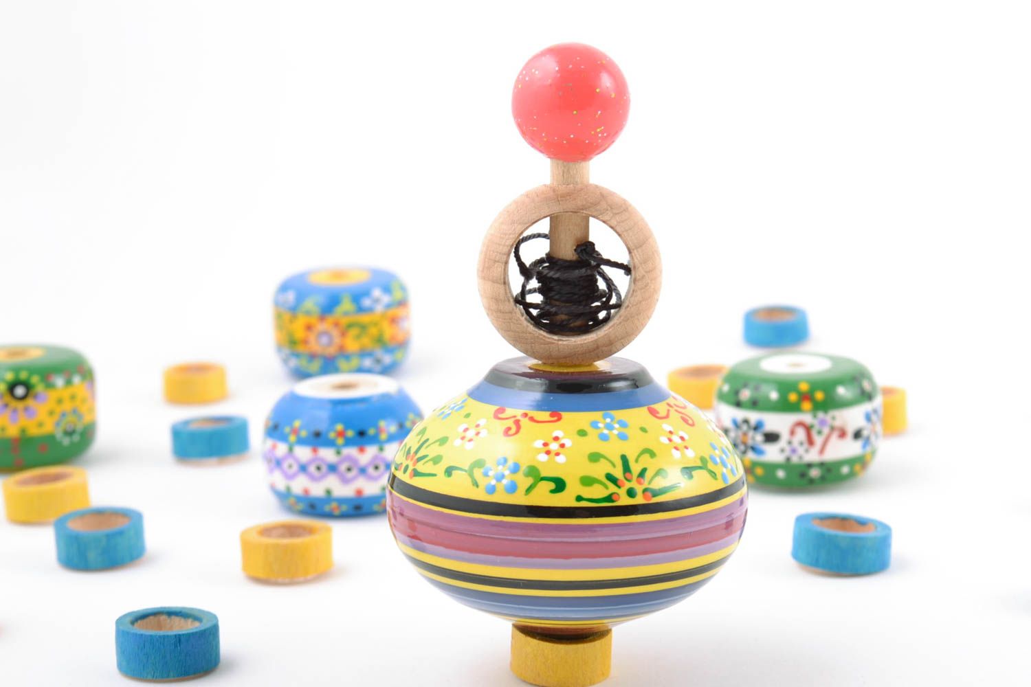 Colorful small handmade wooden spinning top with ring for dexterity development photo 1