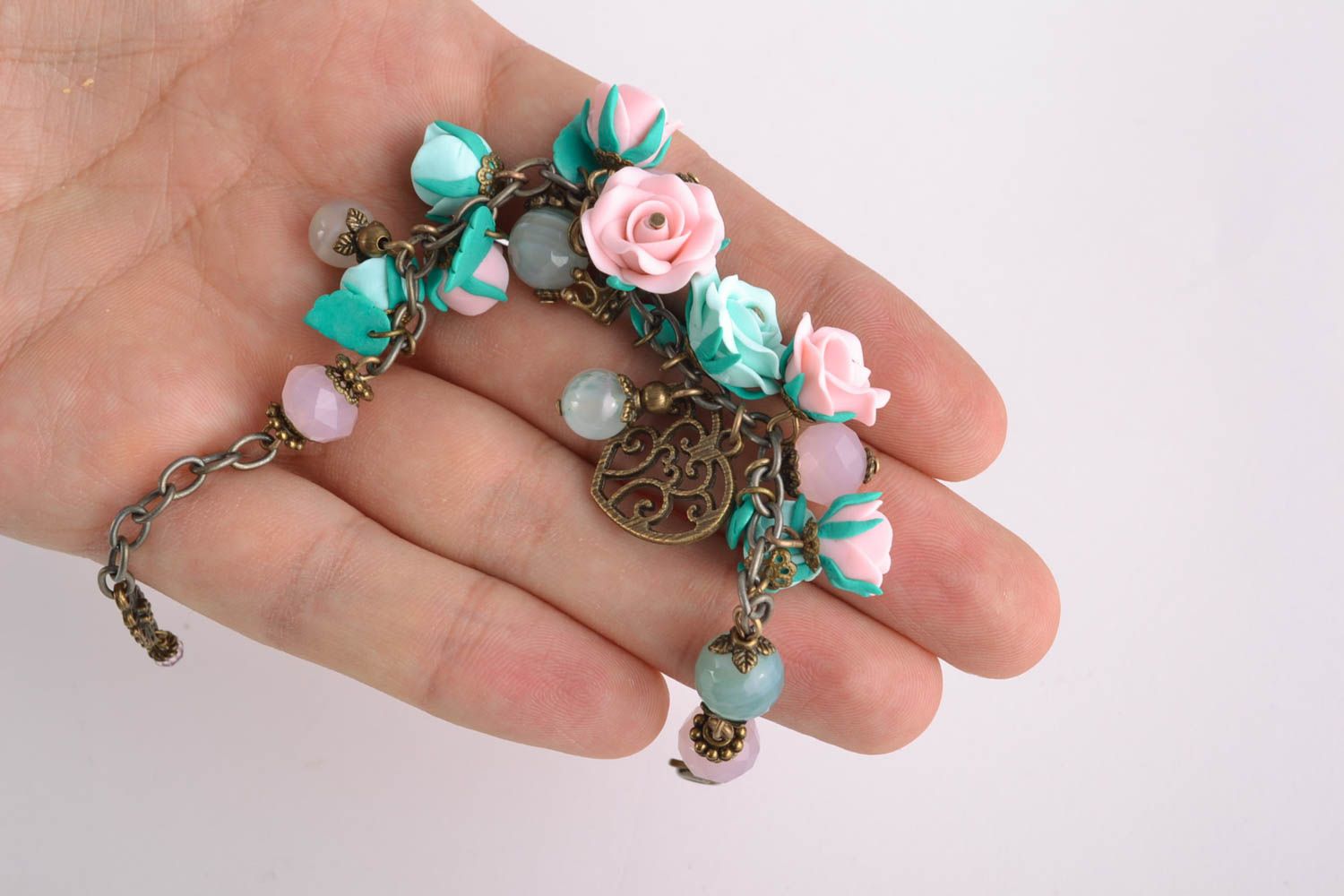 Charm bracelet with pink and turquoise roses and bronze charms photo 3