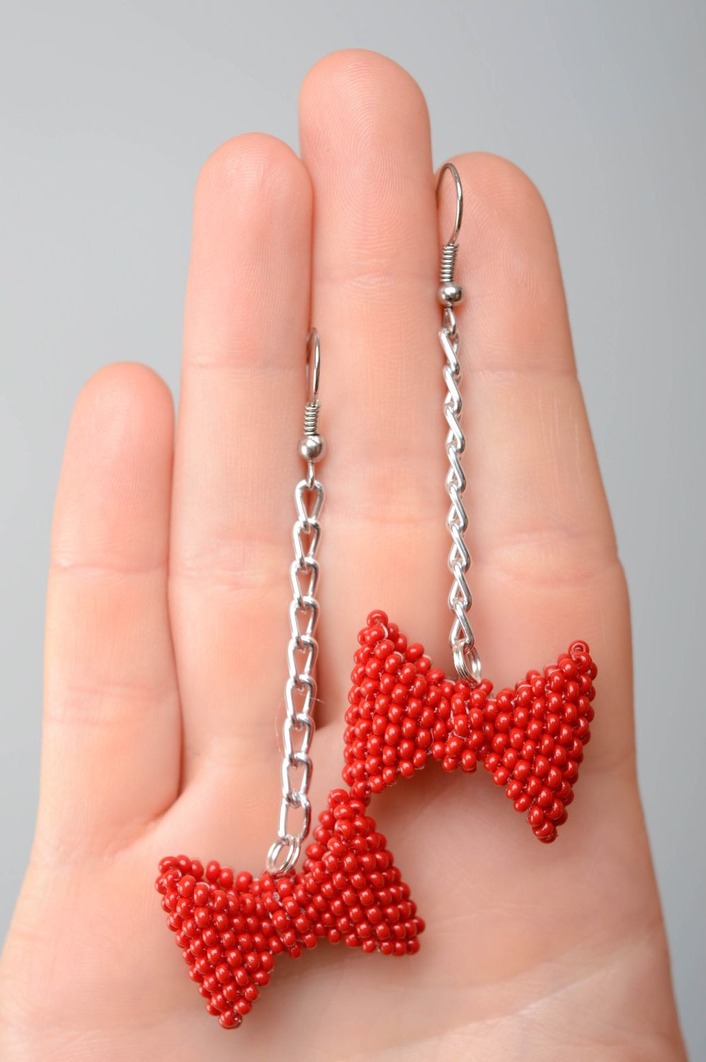 Beaded bow earrings of red color photo 2