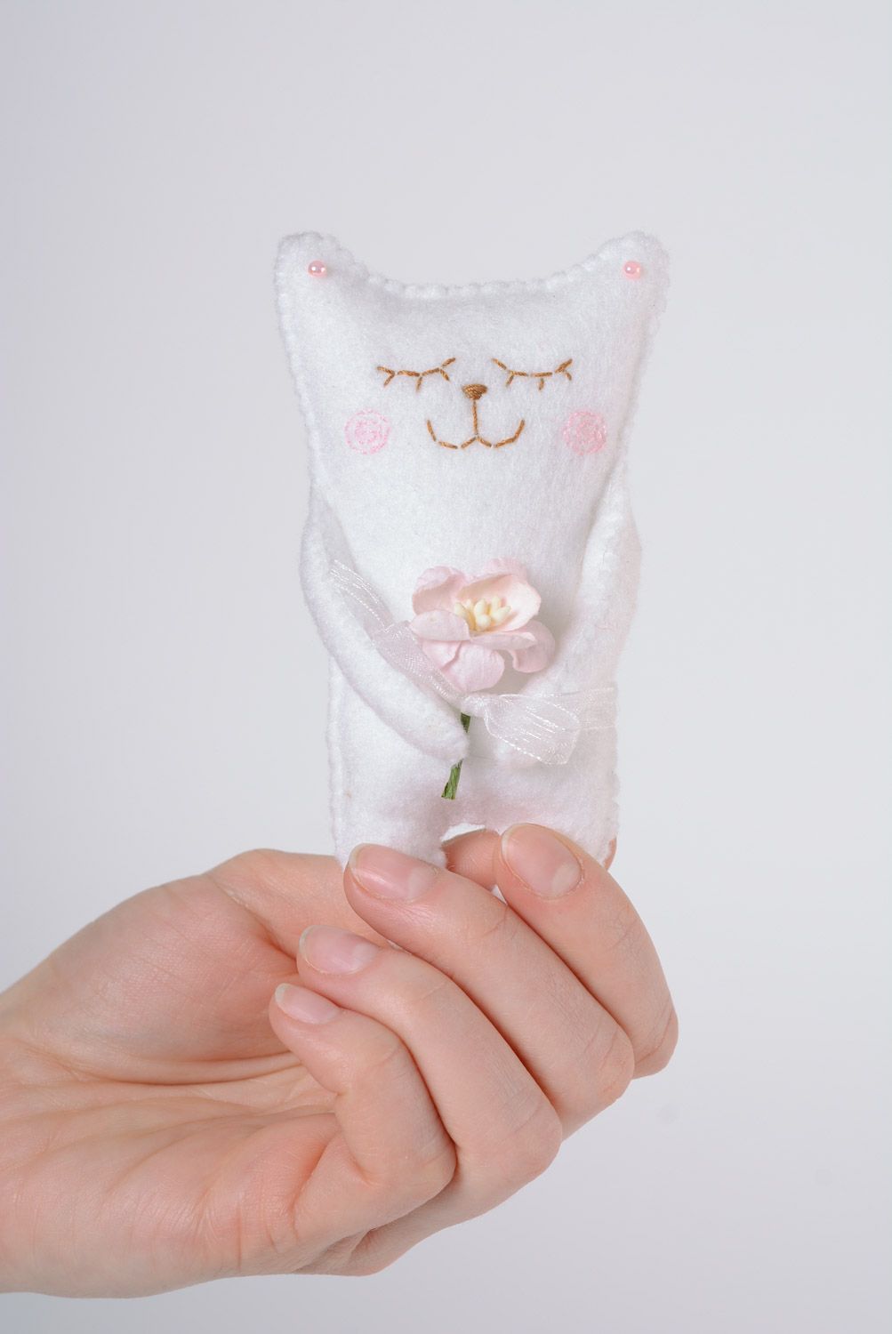 Handmade decorative designer soft toy made of felt white cat with a cute little flower photo 4