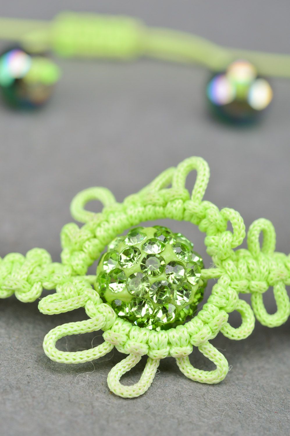 Stylish handmade women's wrist bracelet woven of threads and beads of lime color photo 4