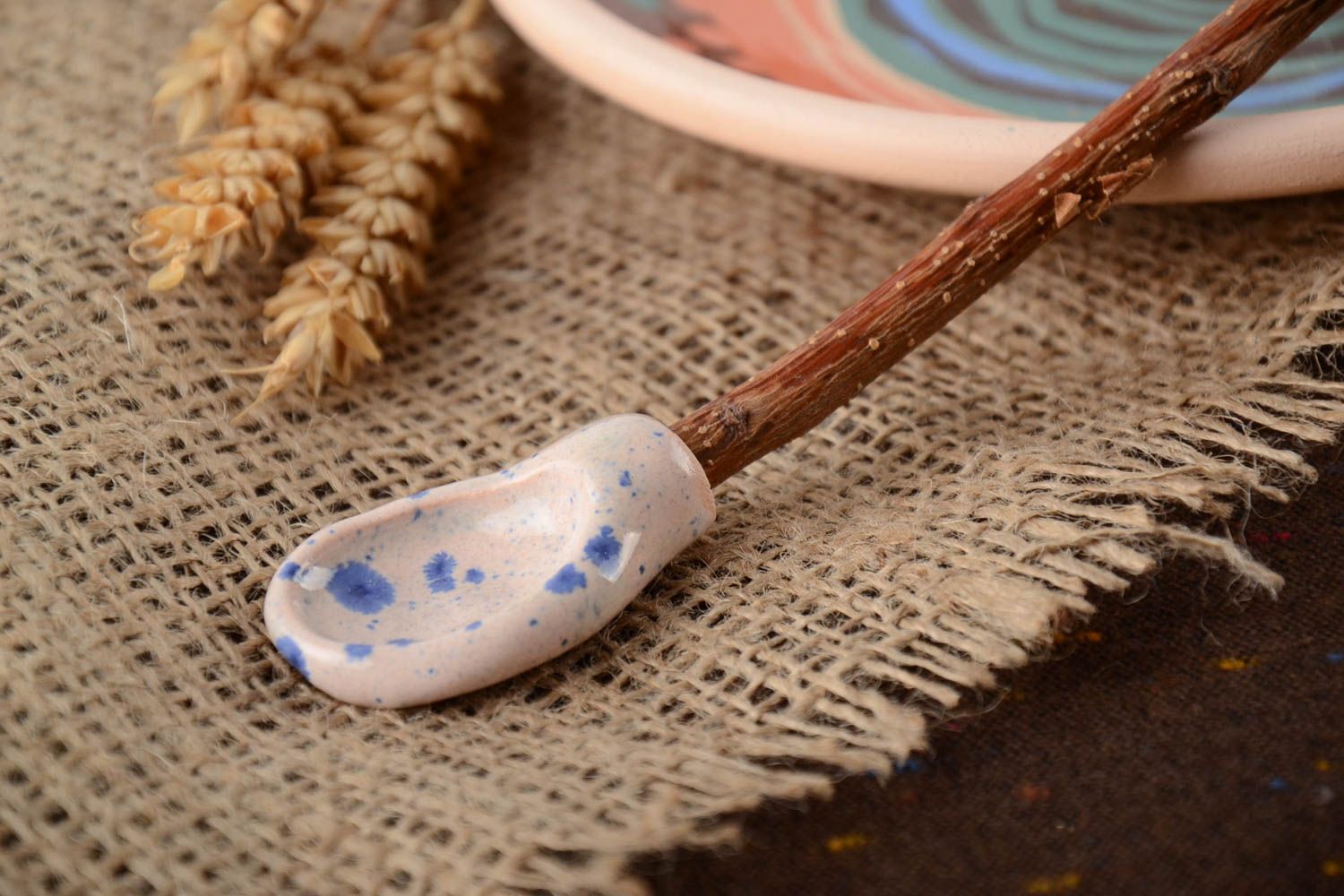Colorful glazed handmade clay spoon with apricot branch handle photo 1