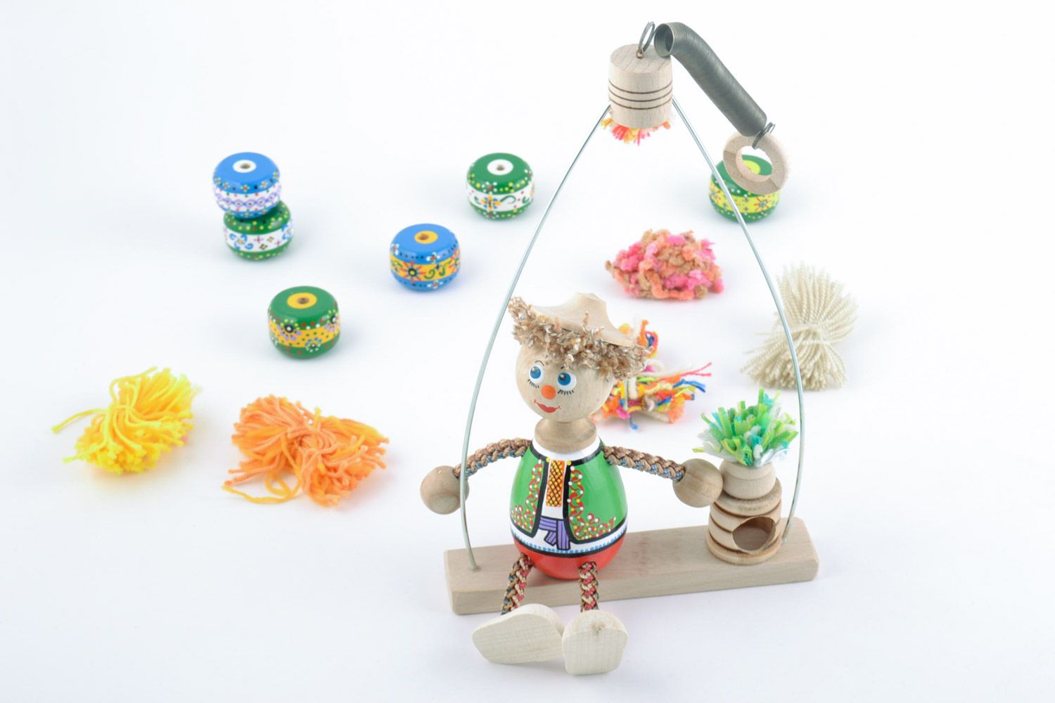 Handmade painted wooden eco toy boy in Ukrainian costume on swing for kids photo 1