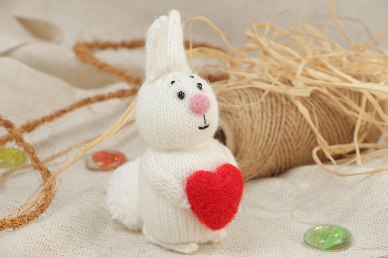 Handmade small soft toy knitted of acrylic threads white rabbit with red heart photo 1