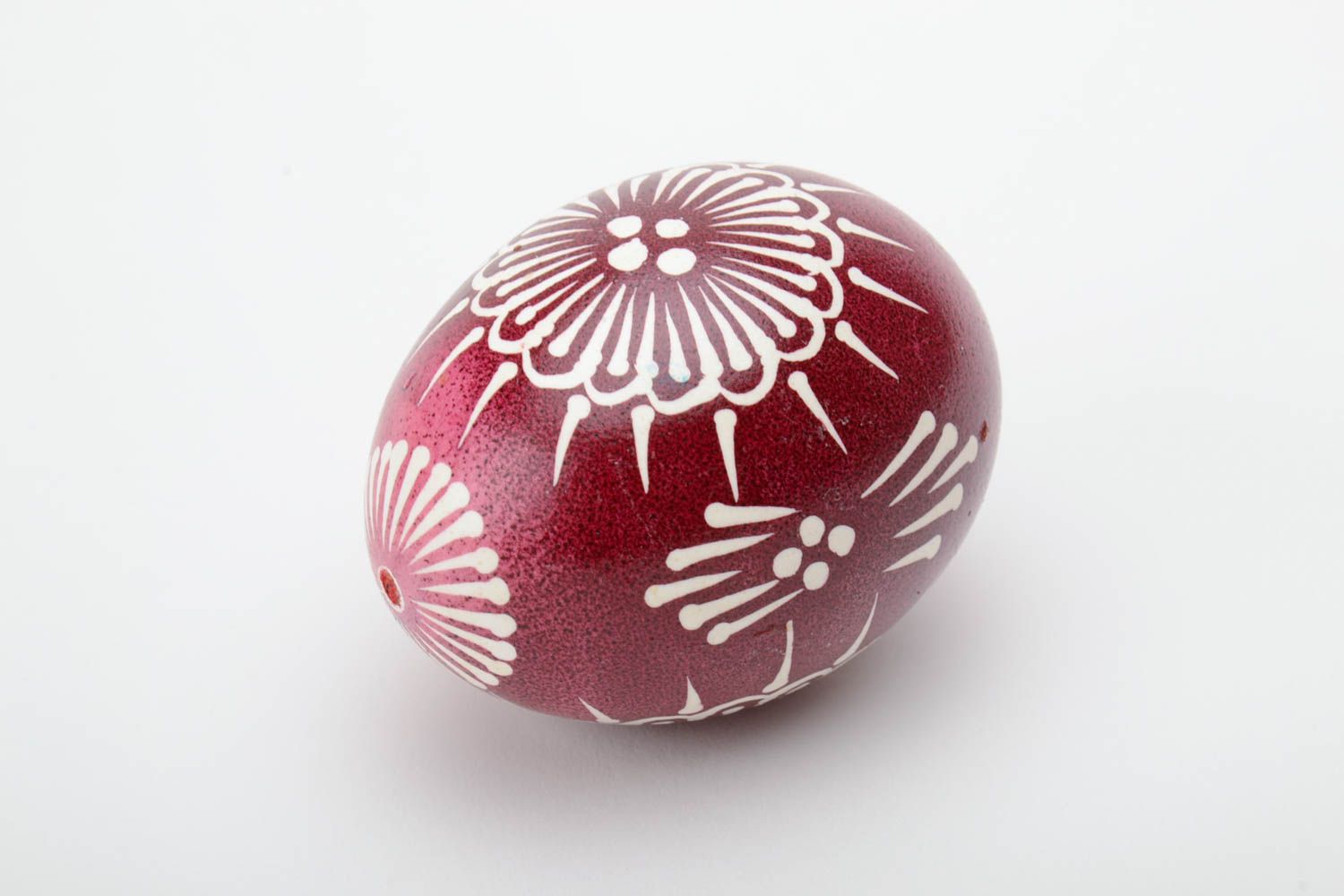 Red and white handmade designer painted Easter egg ornamented using waxing technique photo 2