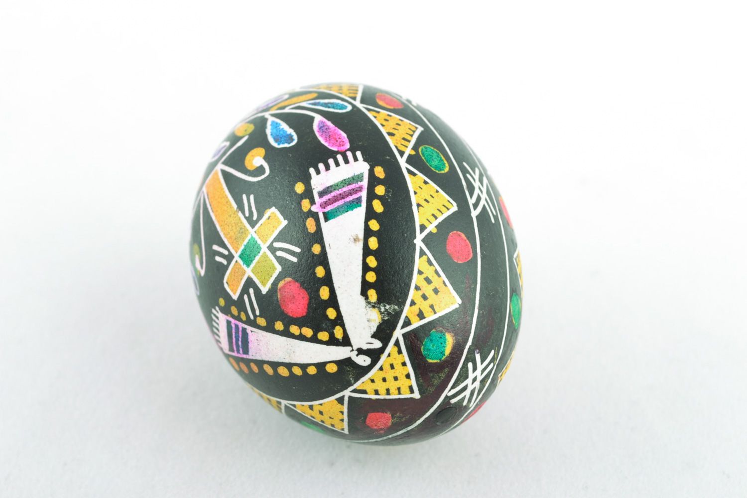 Beautiful chicken Easter egg pysanka with handmade painting on black background photo 3