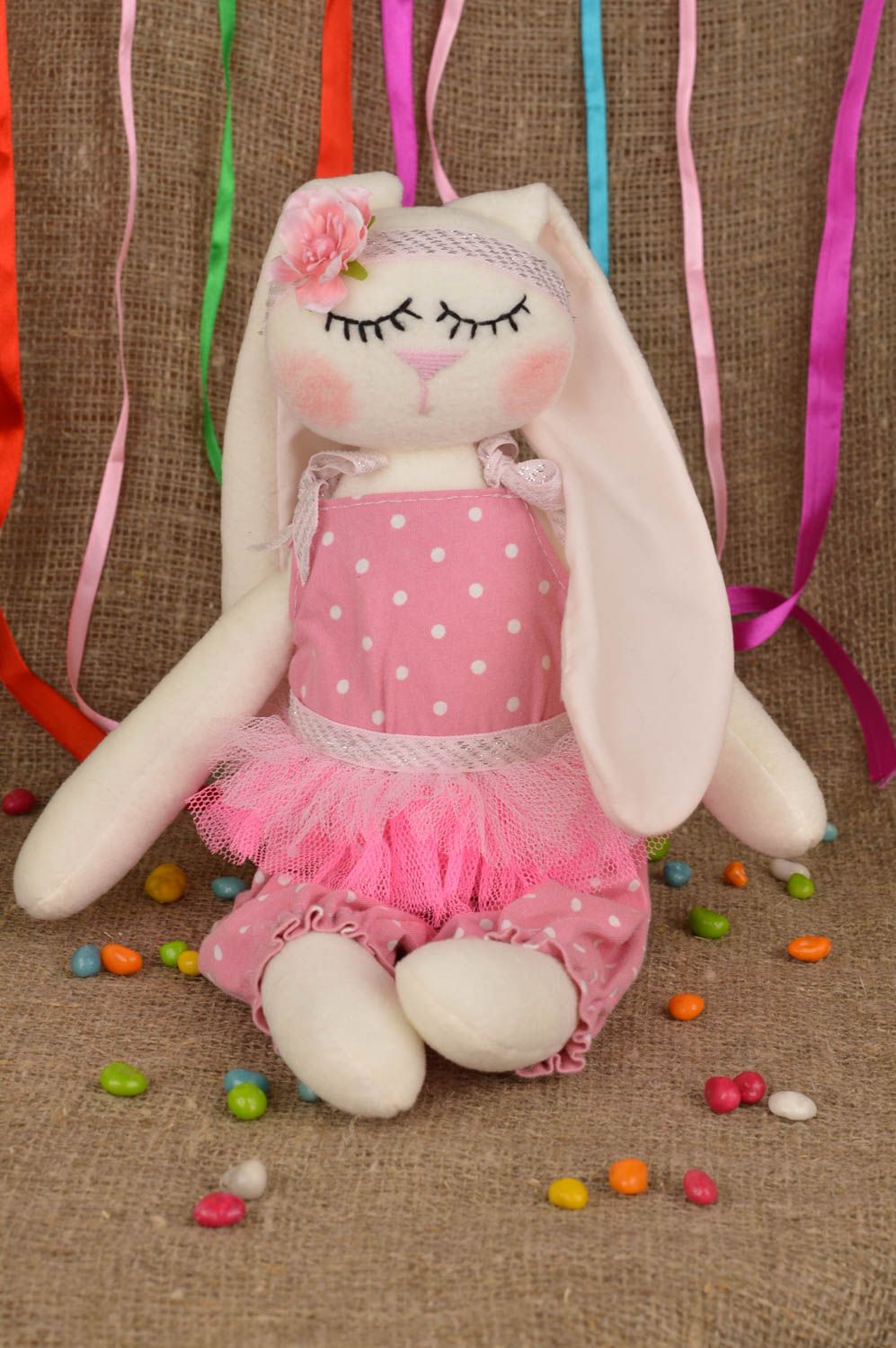 Handmade soft toy sewn of cotton fabric rabbit in pink clothing for children photo 1