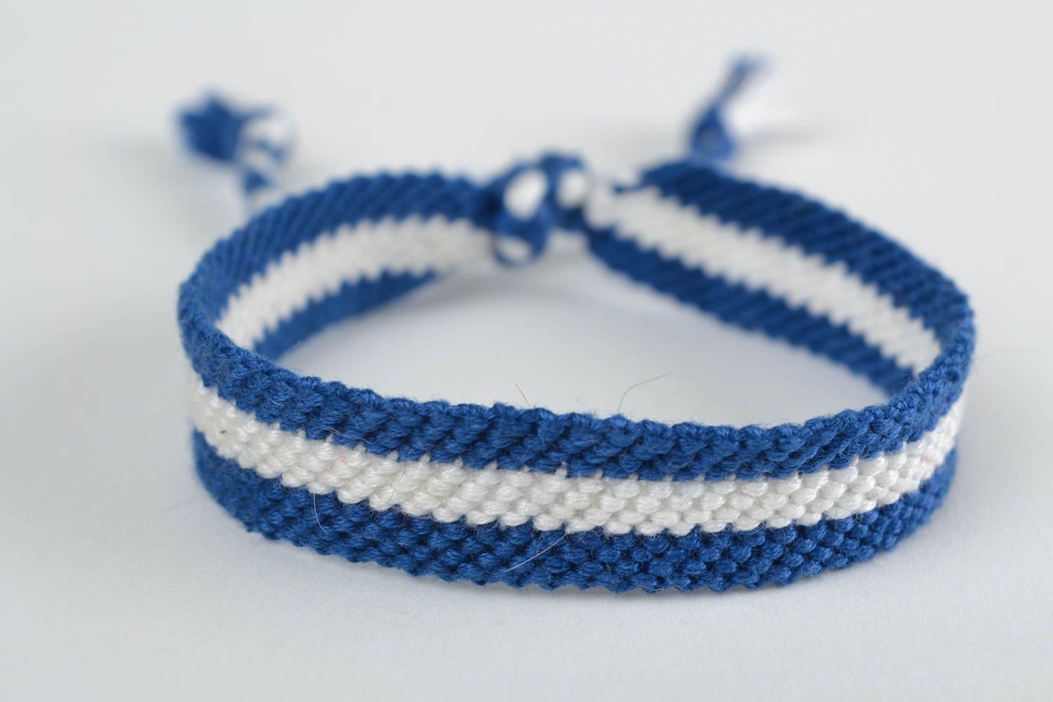 Handmade thin friendship wrist bracelet woven of blue and white threads photo 3