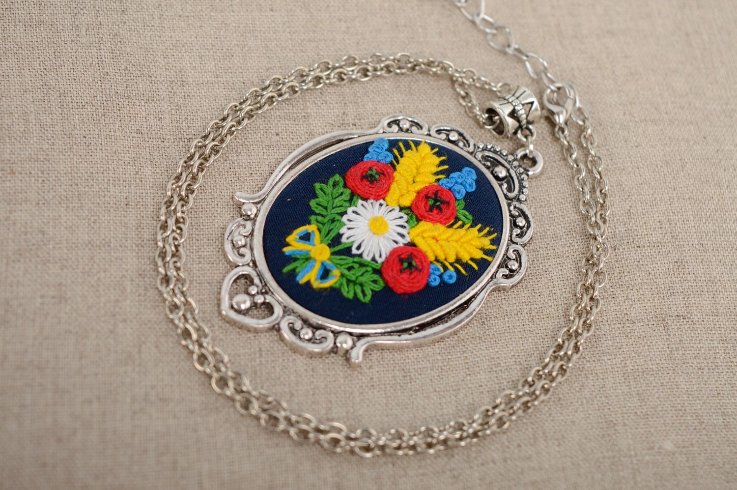 Pendant with French knot embroidery on long chain photo 1