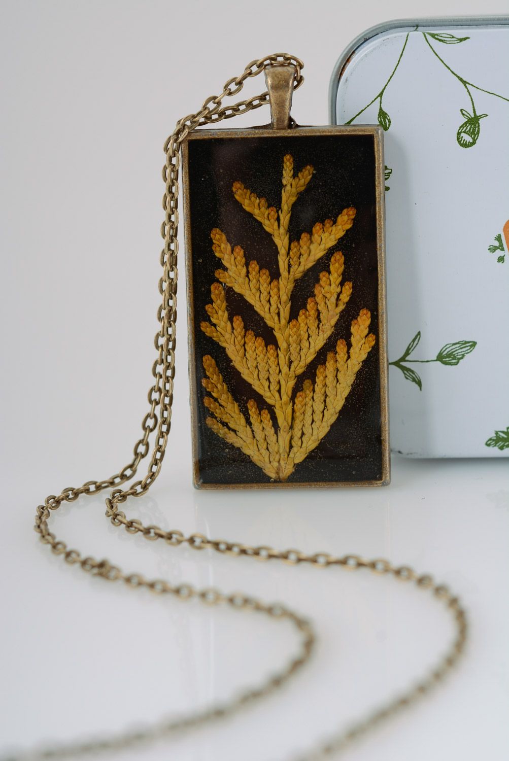 Handmade rectangular dark pendant with natural plants in epoxy resin on chain photo 1