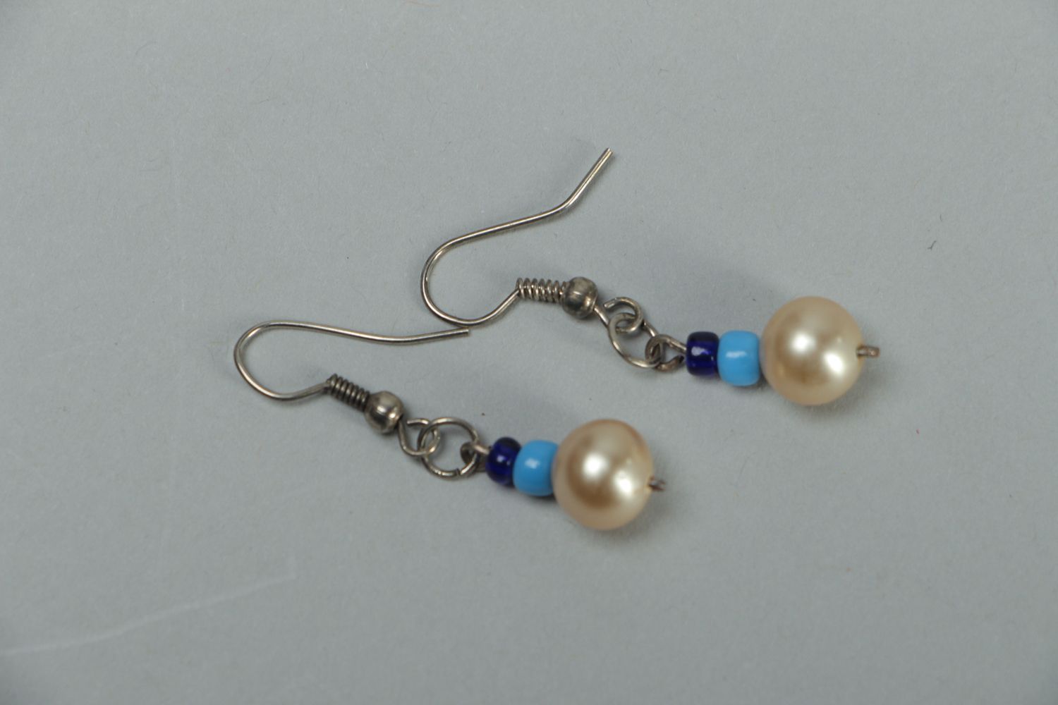 Metal earrings with pearl-like beads photo 1