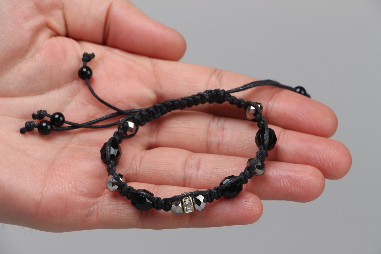 Handmade wrist bracelet woven of waxed cord with glass beads in dark color palette photo 3