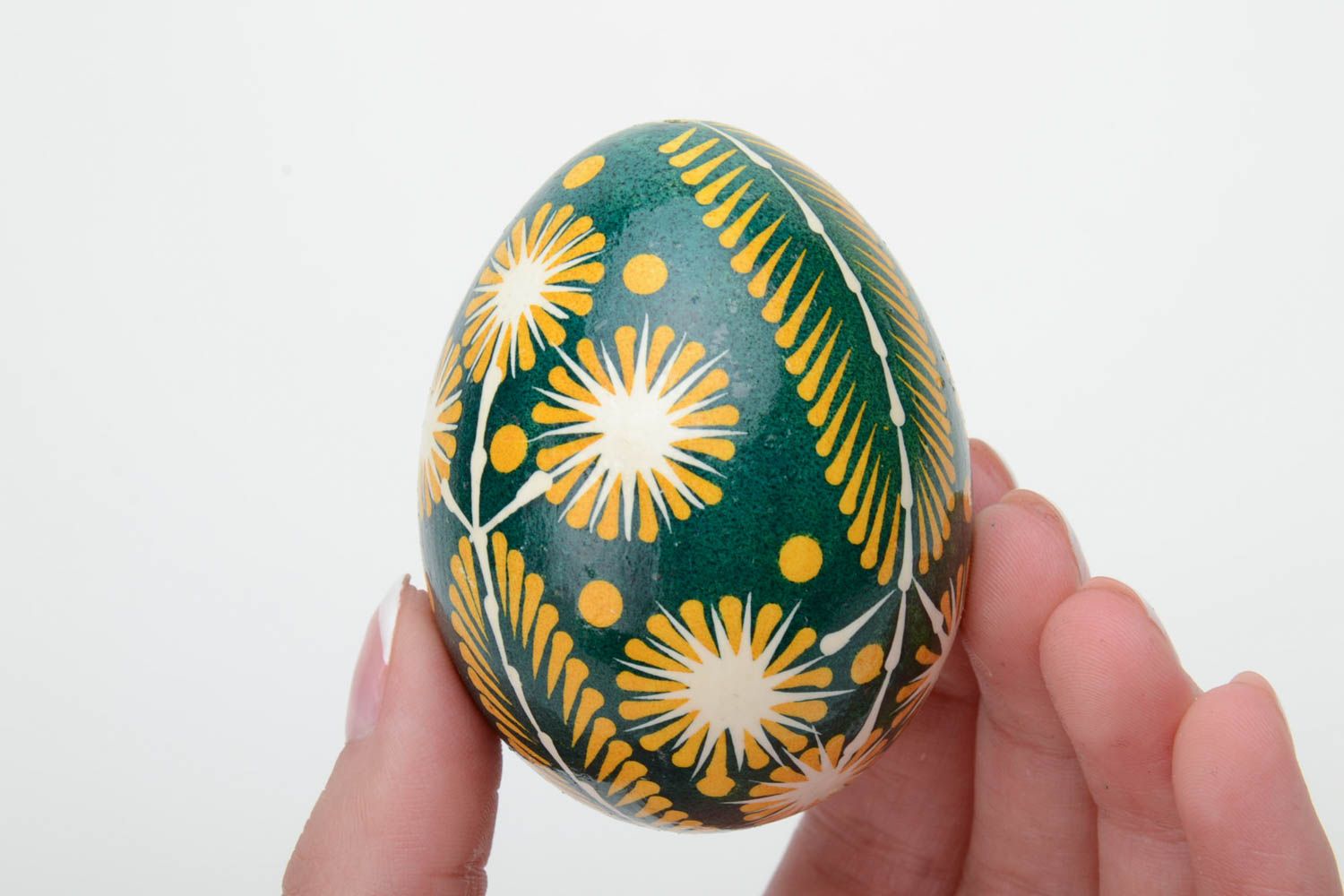 Green and yellow handmade painted Easter egg ornamented using waxing technique photo 5