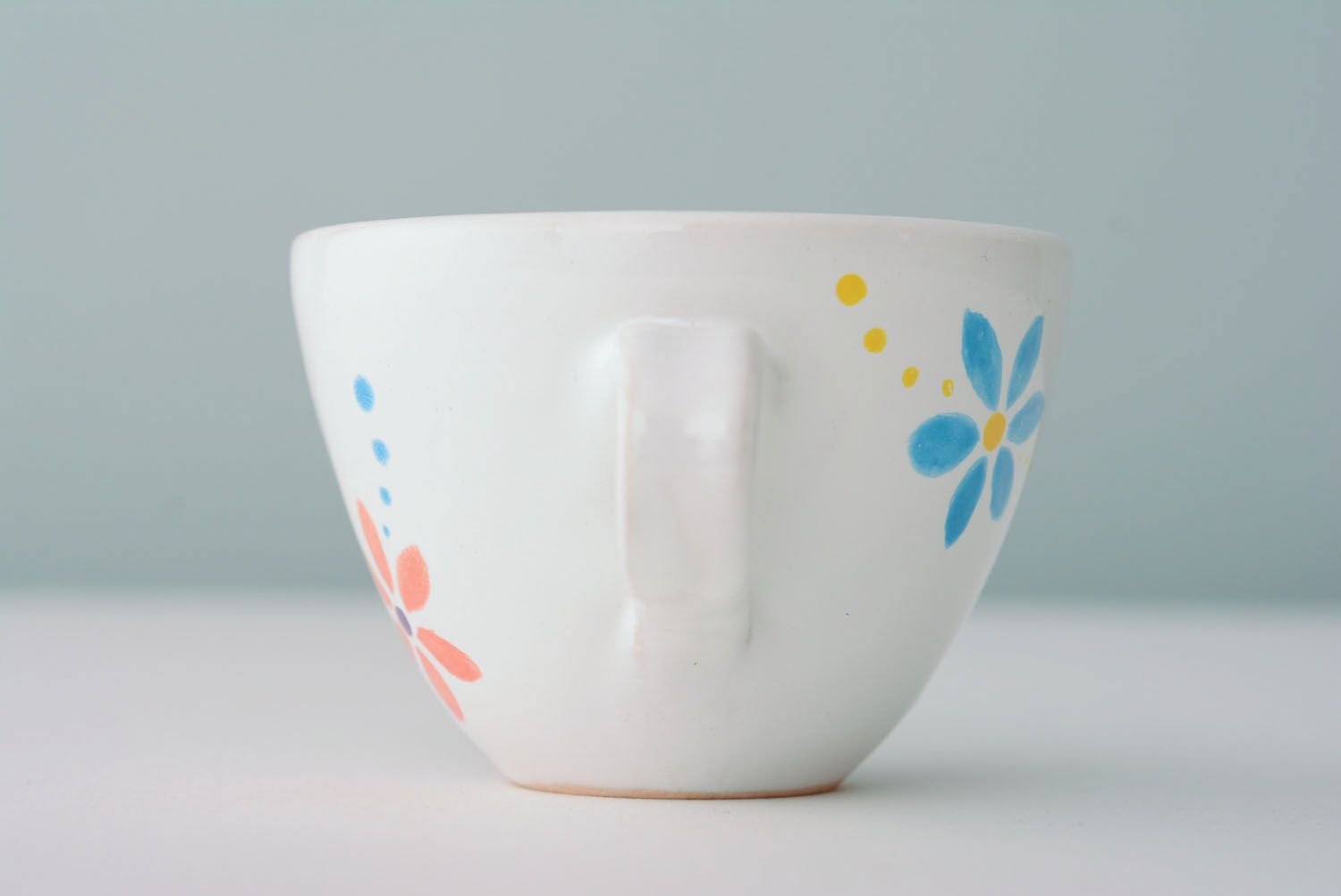 White ceramic drinking handmade 5 oz cup with handle and orange-blue flowers' pattern photo 5