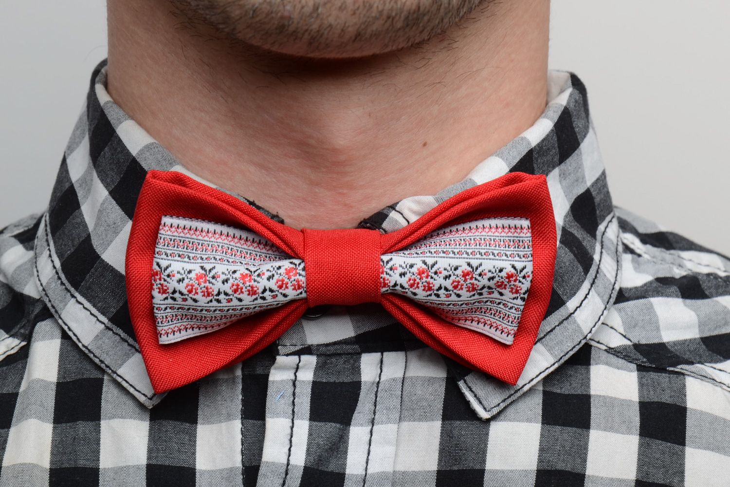 Handmade designer bow tie sewn of red and patterned fabrics in ethnic style photo 1