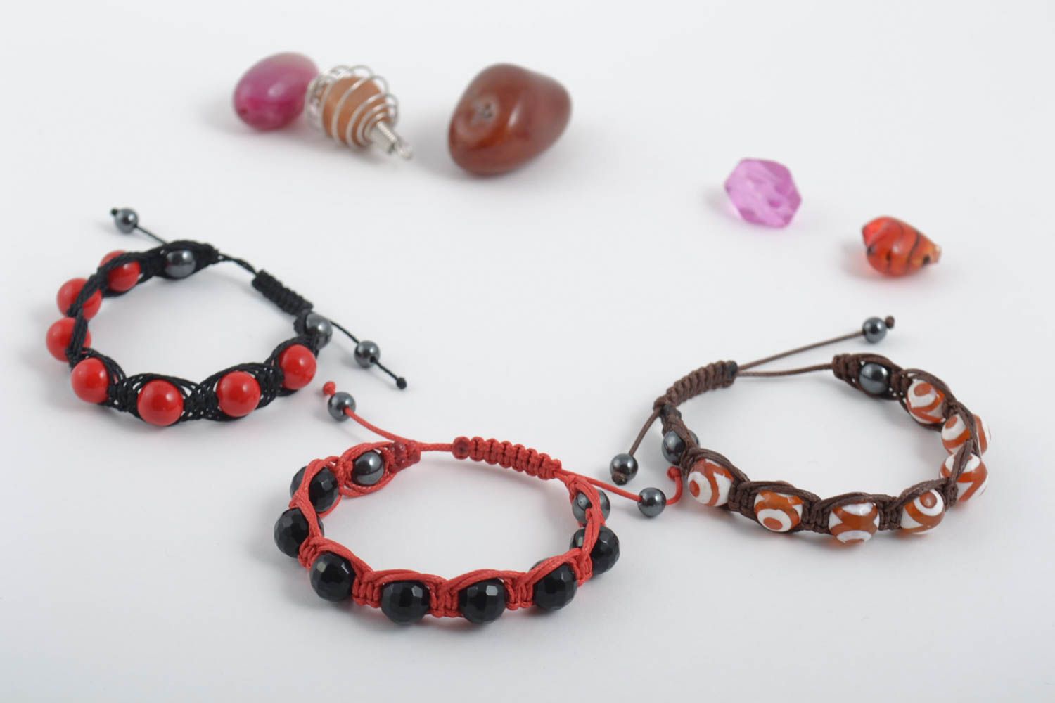 Set of three strand bracelets on red, brown, black cords with red, black, white, and brown beads for women photo 1
