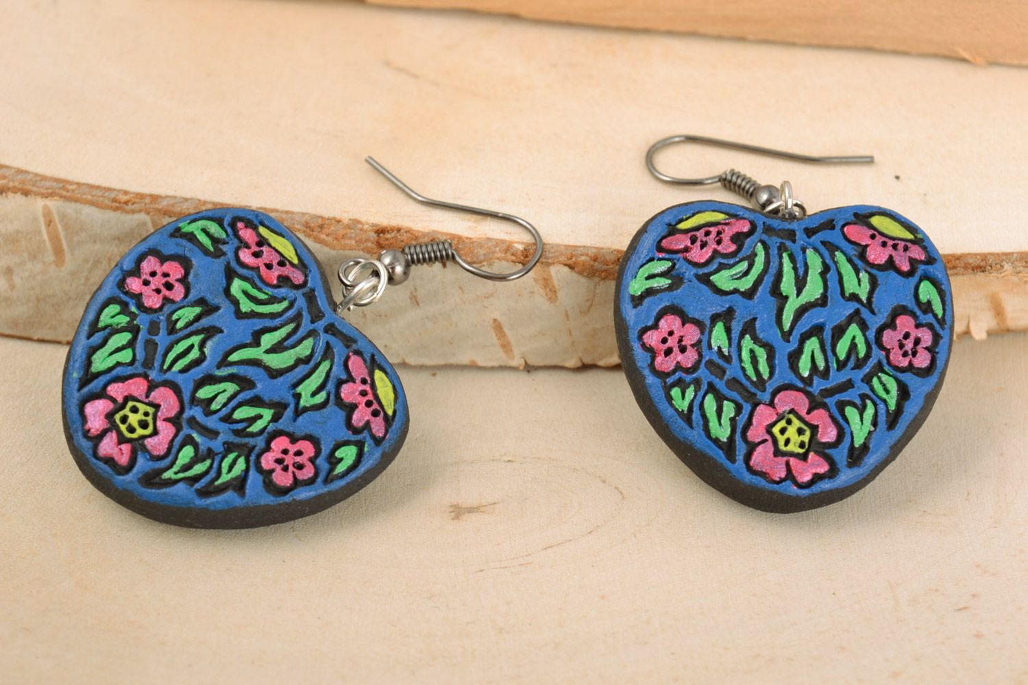 Handmade heart-shaped painted blue ceramic dangling earrings with floral pattern photo 1