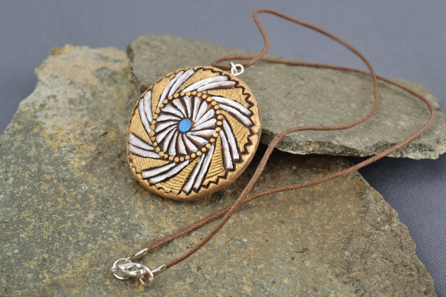 Unusual beige handmade round clay pendant with brown cord photo 1
