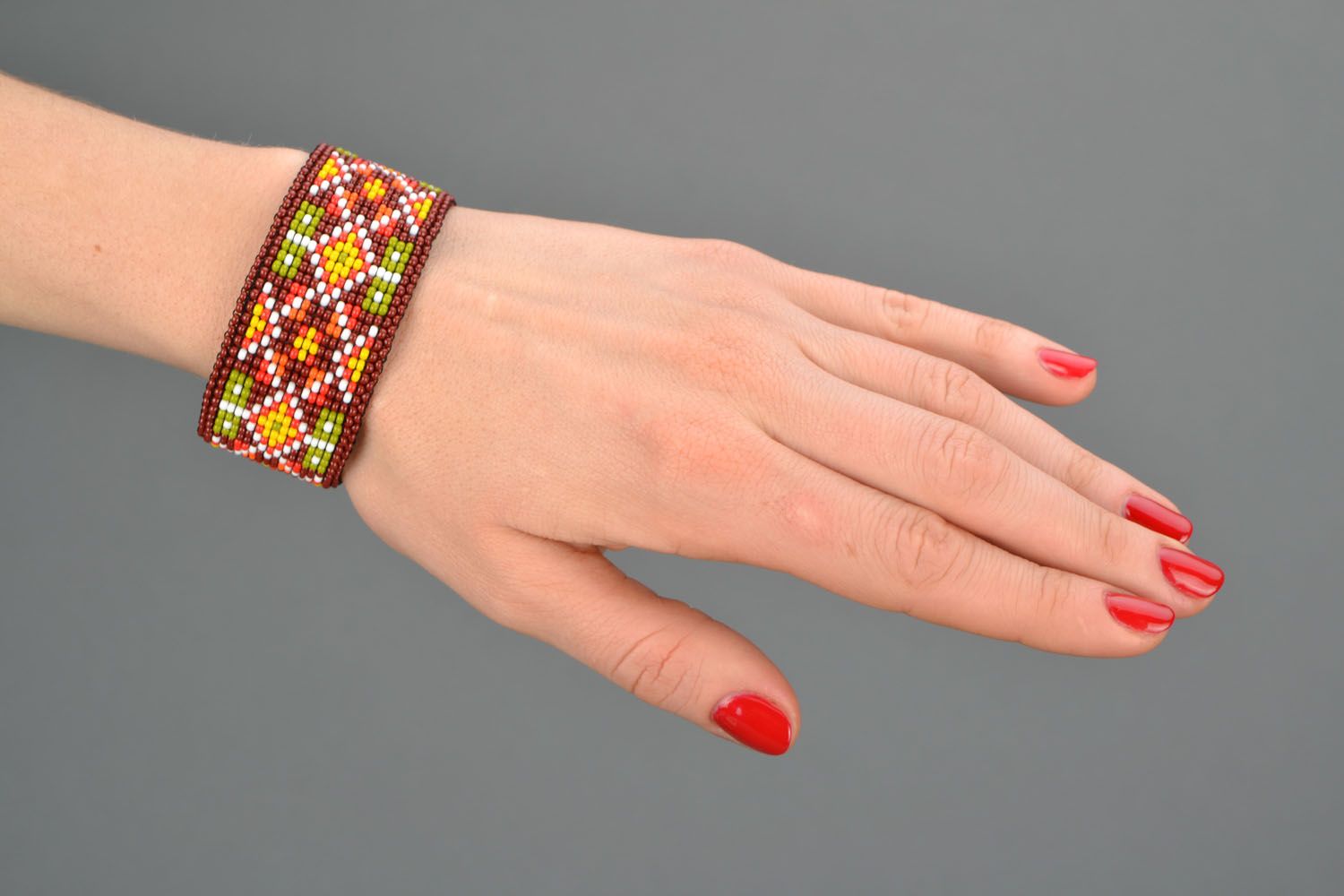 Cuff beaded bracelet in orange dark red and yellow colors photo 2