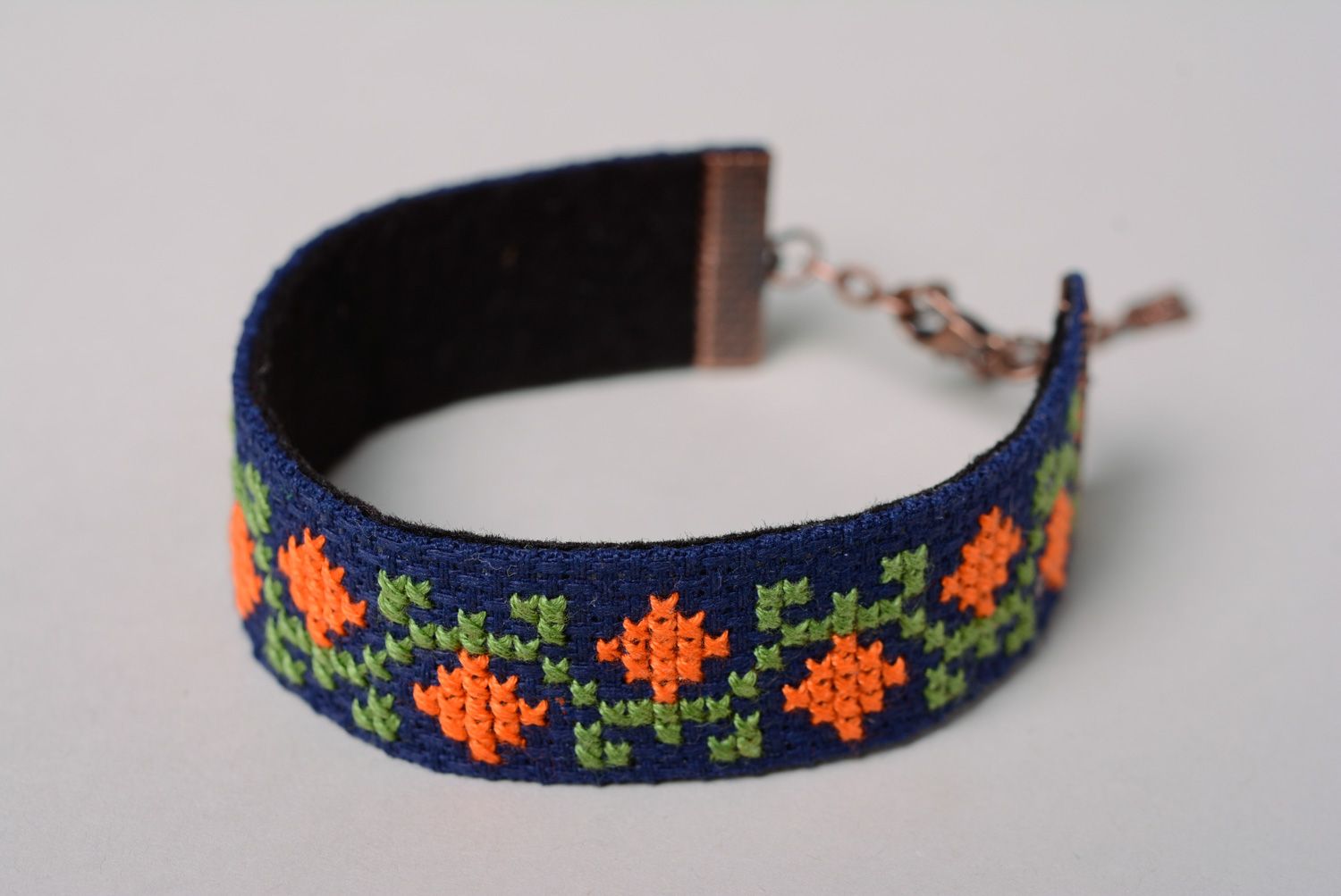 Handmade wrist bracelet with cross stitch embroidery on blue background for women photo 2