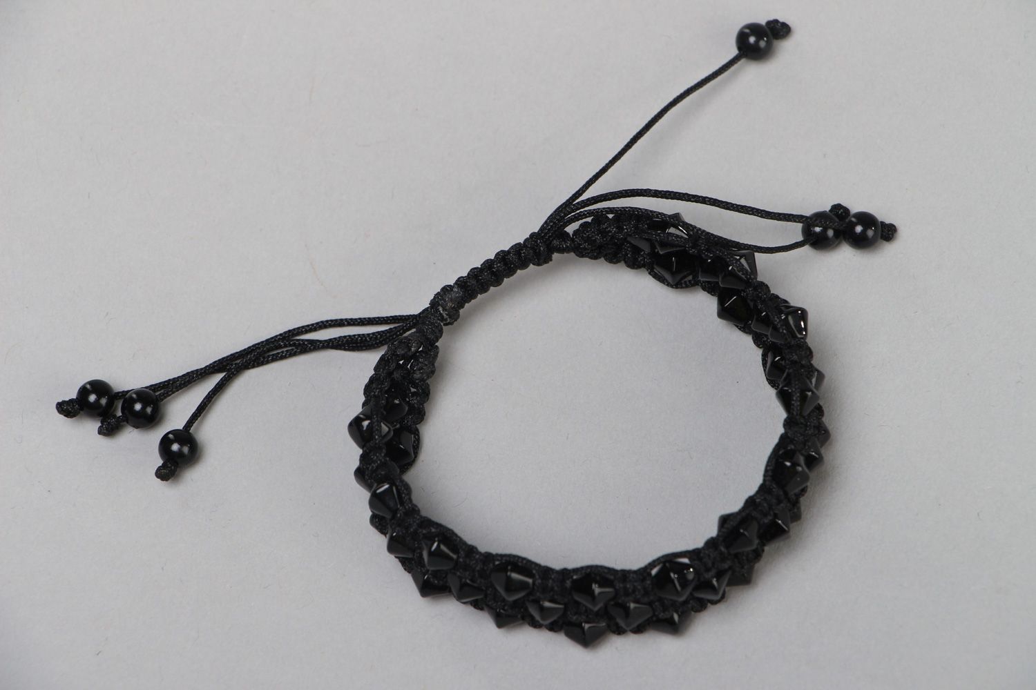 Handmade laconic friendship bracelet woven of black cord and beads for women photo 2