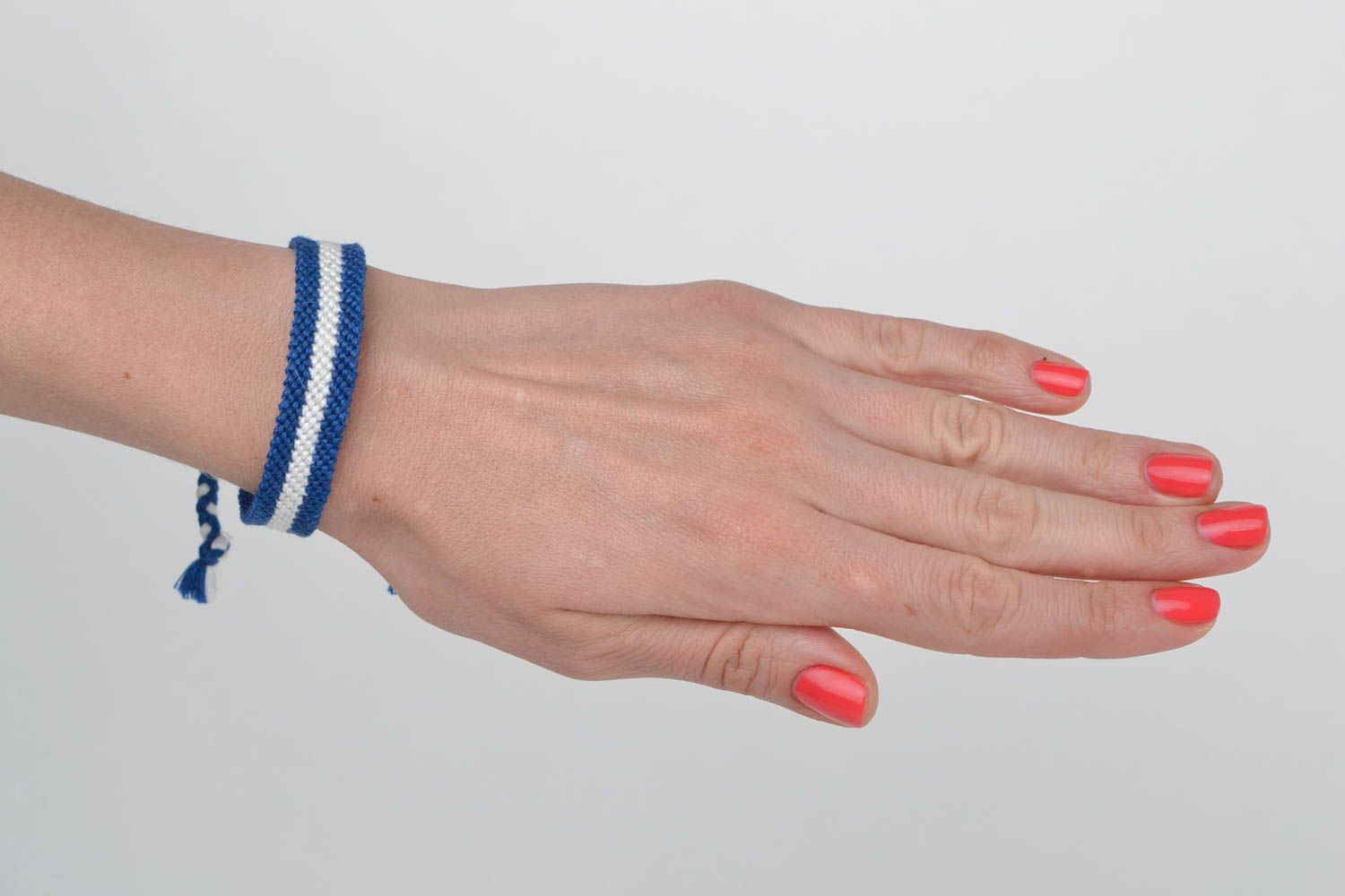 Handmade thin friendship wrist bracelet woven of blue and white threads photo 2