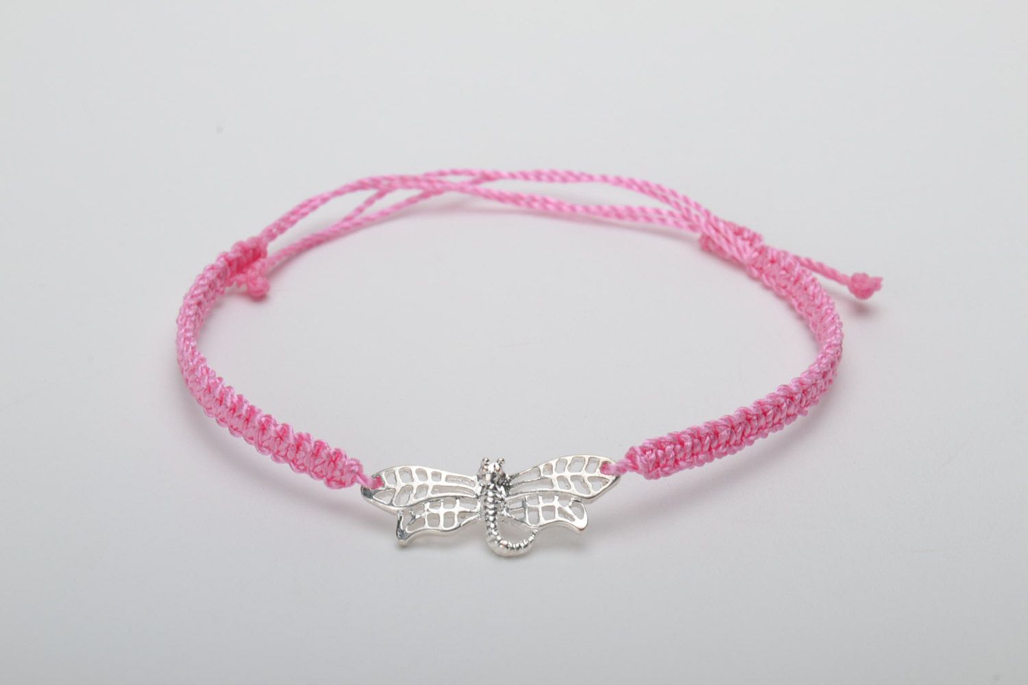 Handmade pink women's woven capron thread bracelet with metal charm in the shape of butterfly photo 5