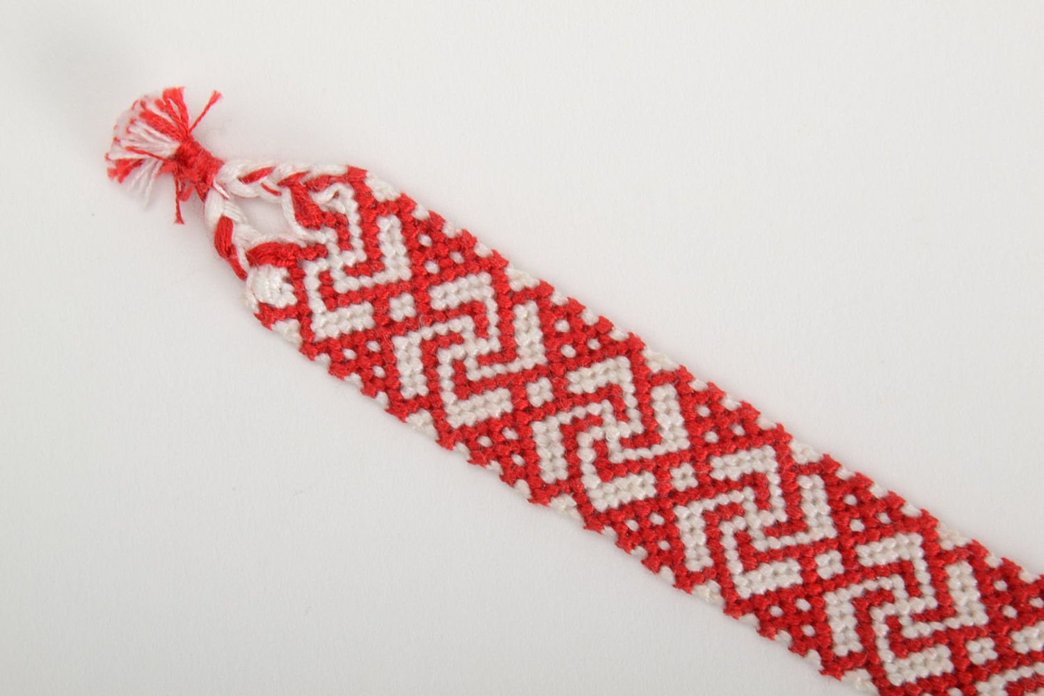 Handmade ethnic friendship wrist bracelet woven of red and white threads photo 4