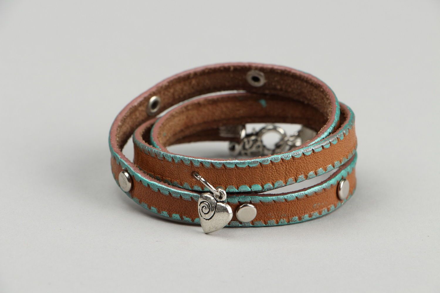 Leather bracelet on the hand with rivets photo 3