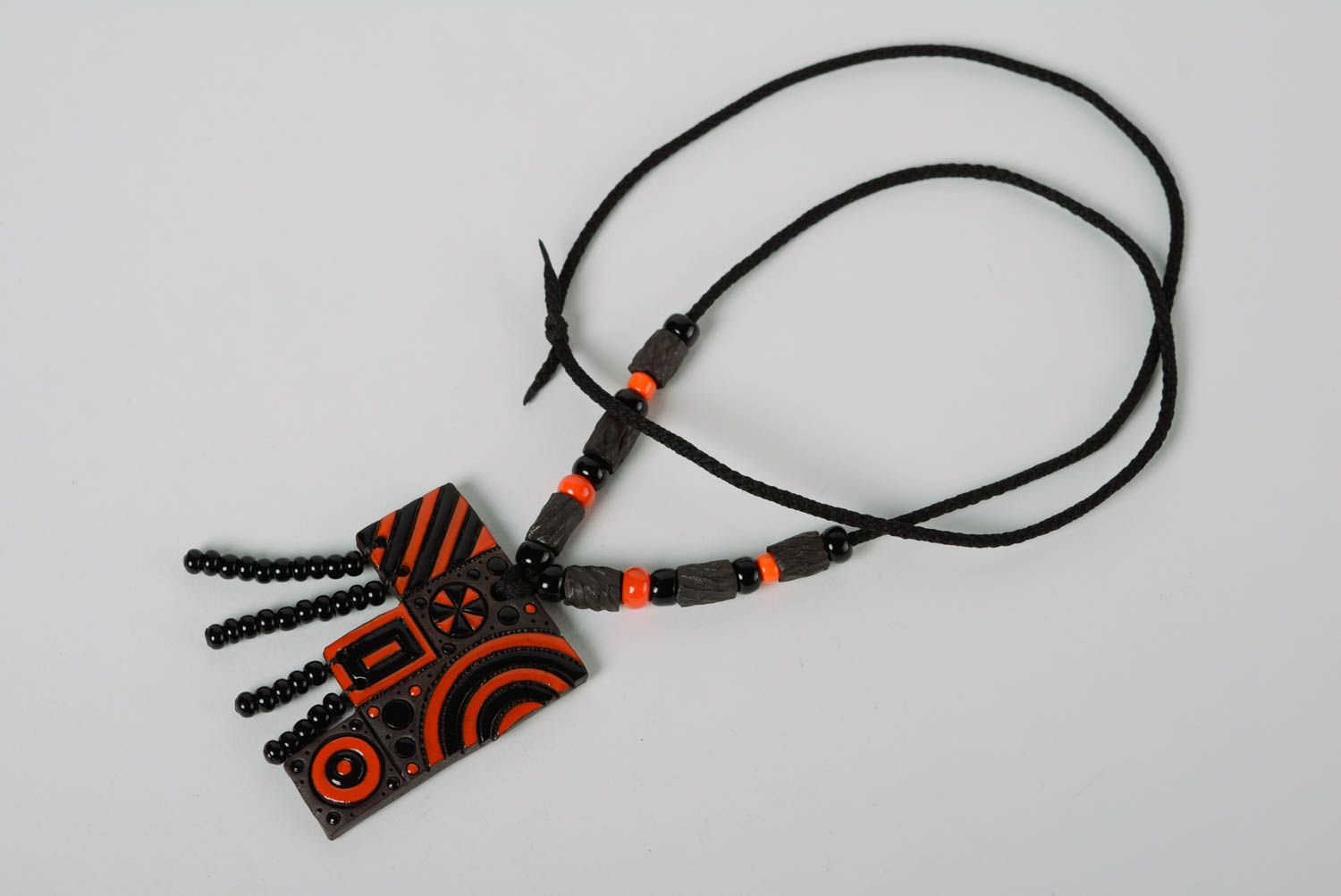 Handmade designer clay pendant painted with enamel and equipped with cord and beads photo 1