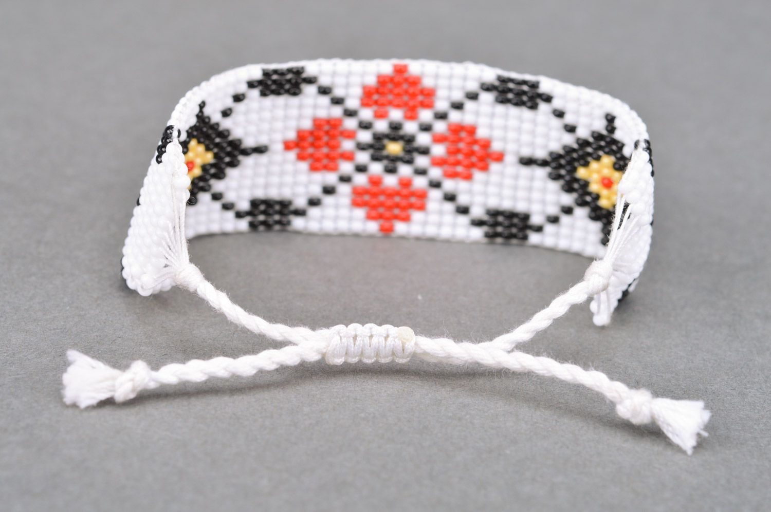 Handmade wide women's woven bead bracelet of white color with ornament photo 5