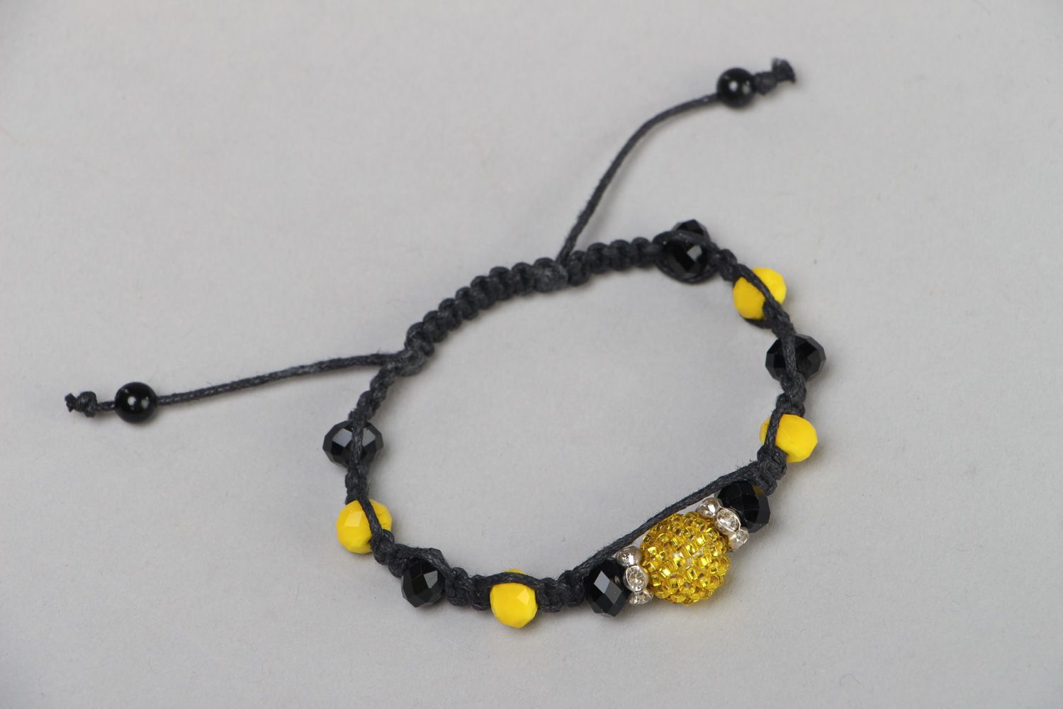 Handmade friendship bracelet woven of black cord and yellow beads for women photo 2