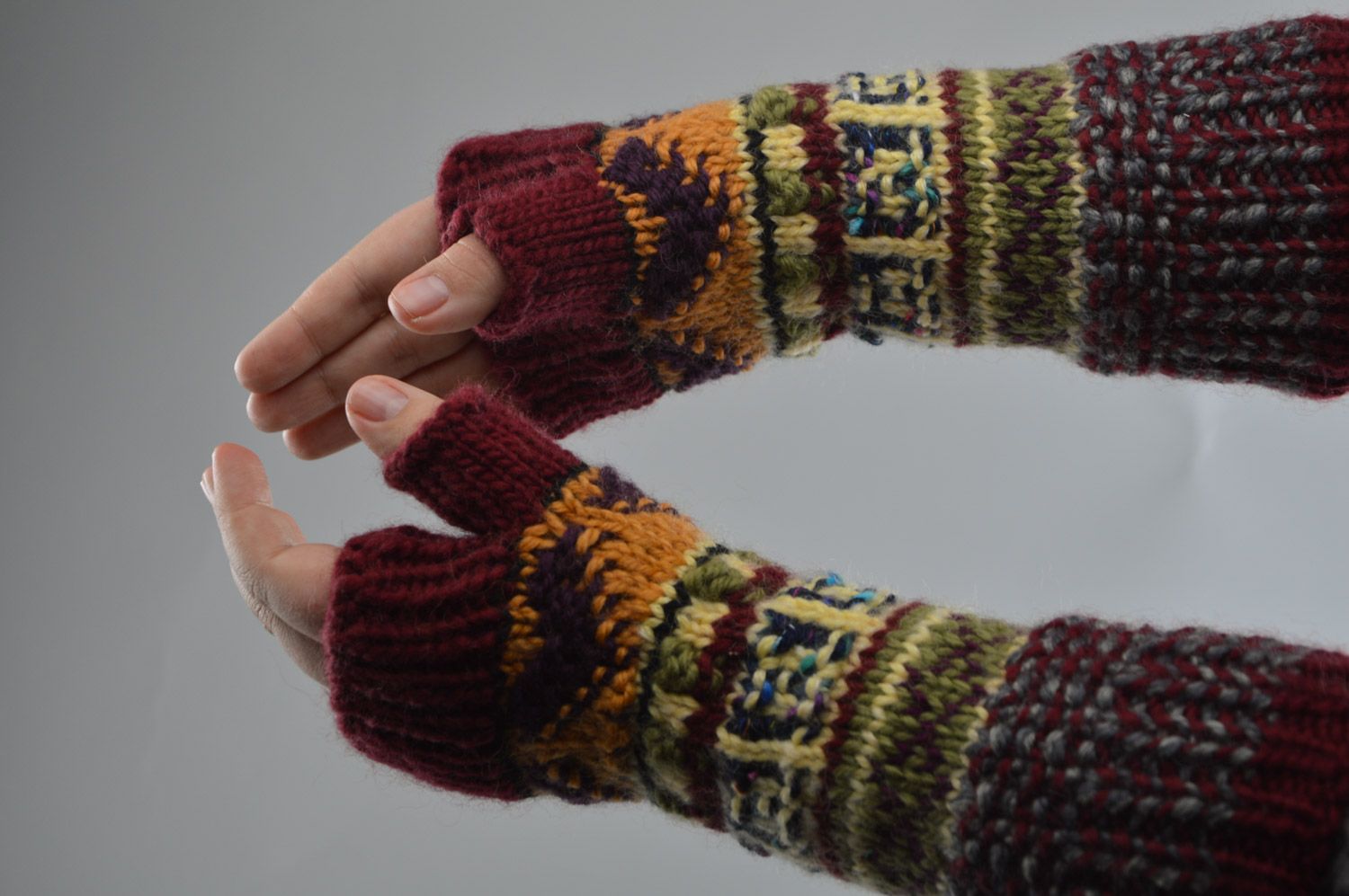Beautiful handmade fingerless gloves knitted of wool with colorful ornaments photo 3