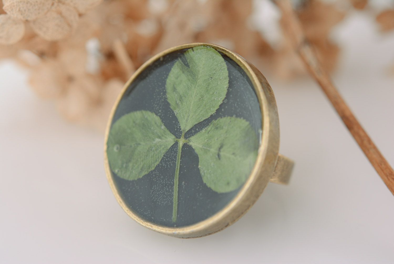 Handmade black round ring on metal basis with clover in epoxy resin for women photo 1