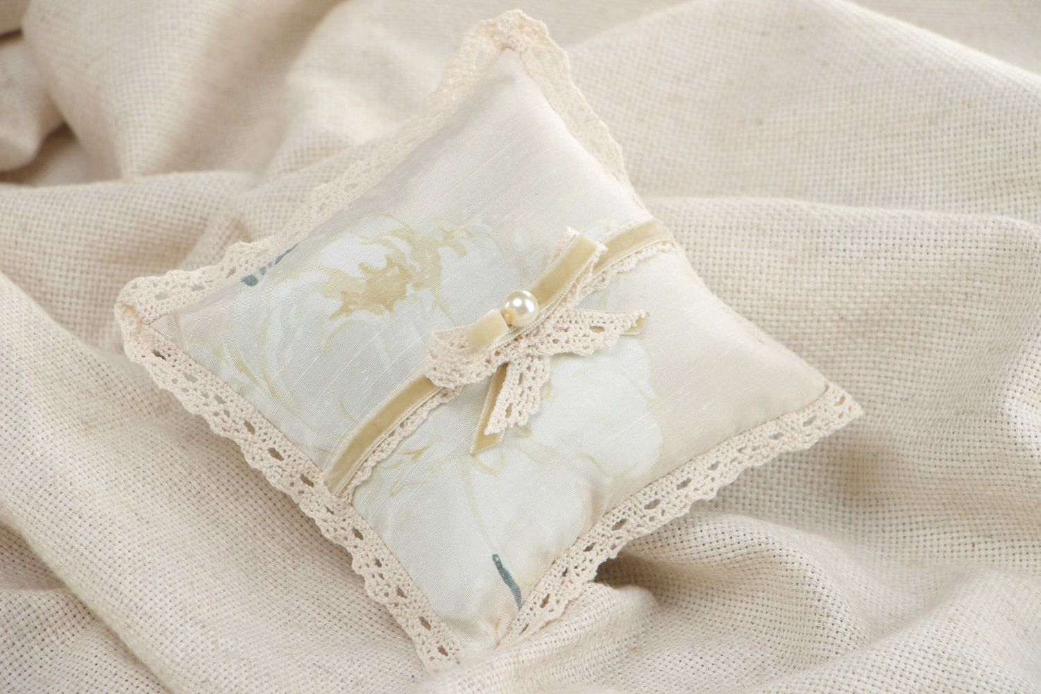 Handmade wedding ring bearer pillow sewn of ivory-colored silk fabric with bow photo 1