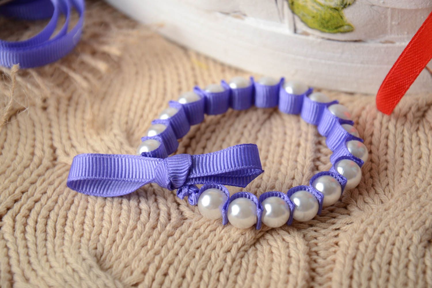 Handmade thin wrist bracelet with plastic pearl like beads and violet rep ribbon photo 1
