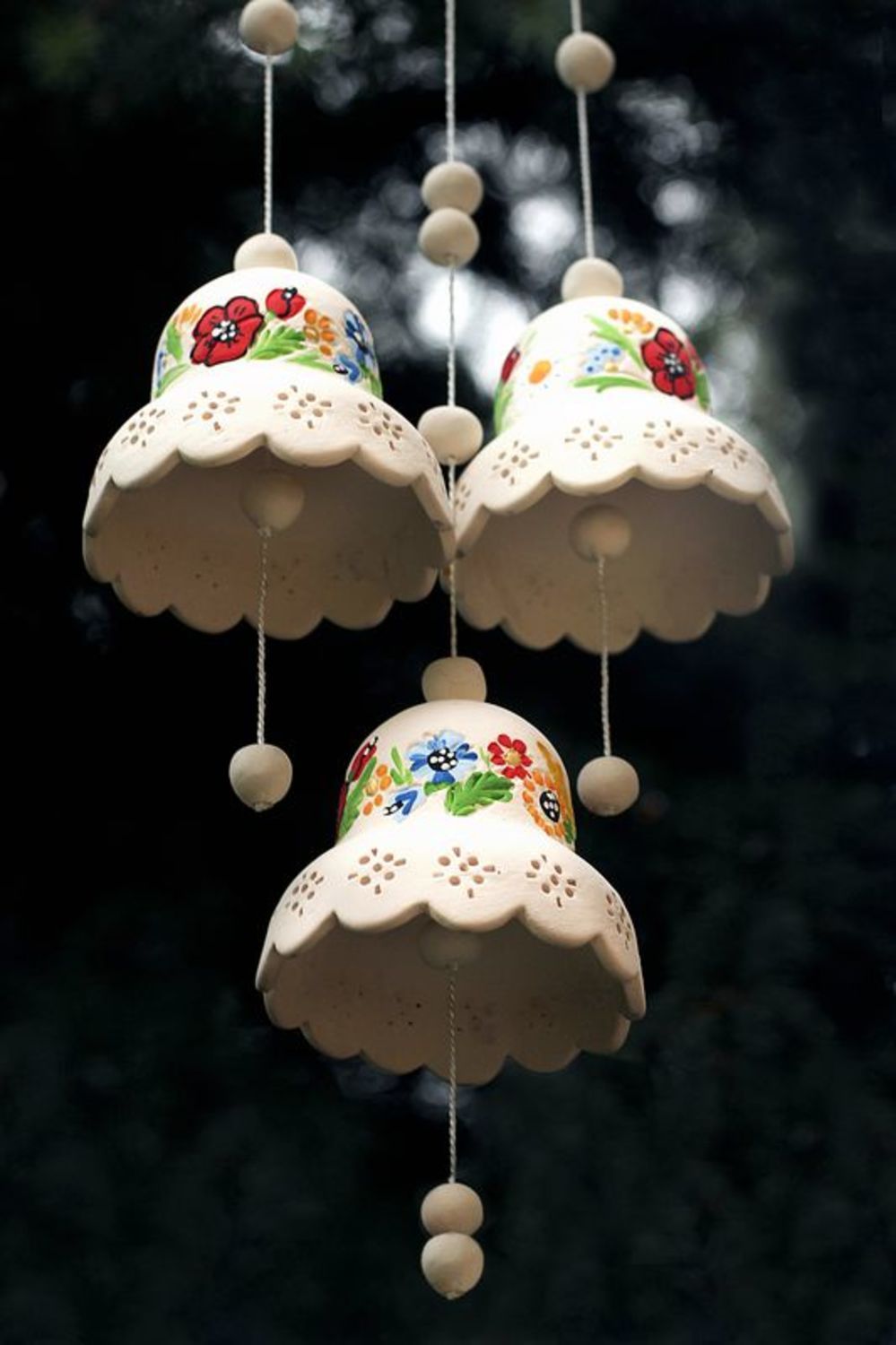 Campanillas de cerámica en un suspensiòn con flores foto 4