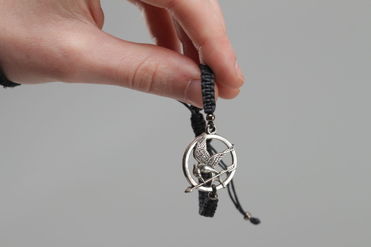 Handmade black friendship wrist bracelet woven of cord with metal charm Mokingjay photo 5