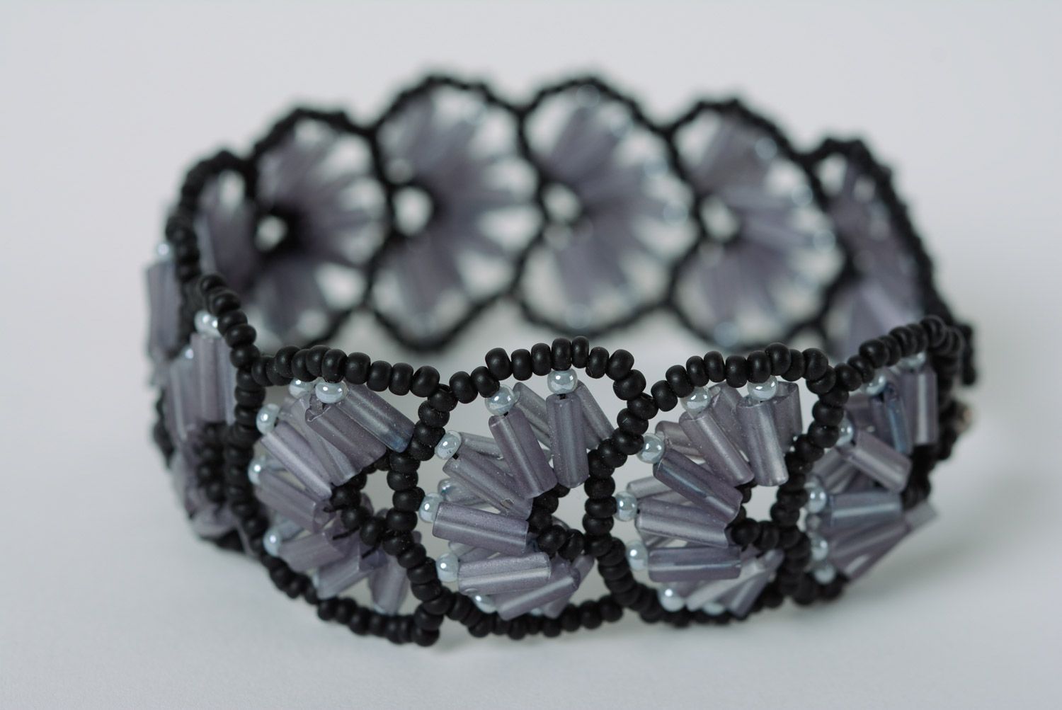 Handmade evening lacy wrist bracelet woven of beads in dark color palette  photo 2
