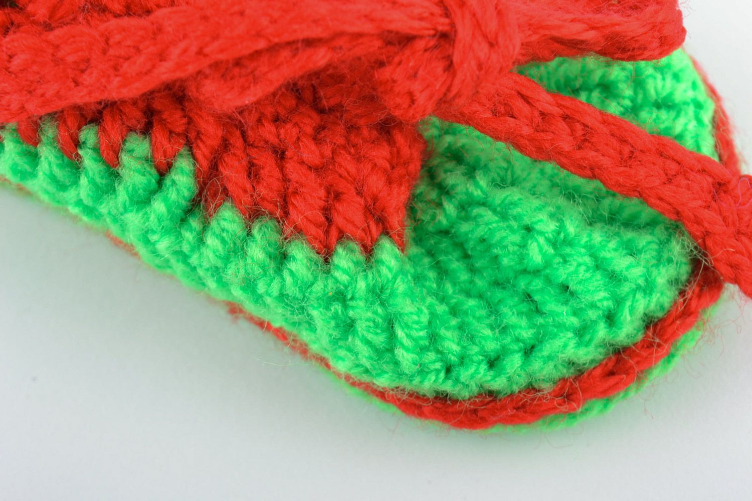 Red and green handmade knitted warm baby booties in the shape of shoes photo 3