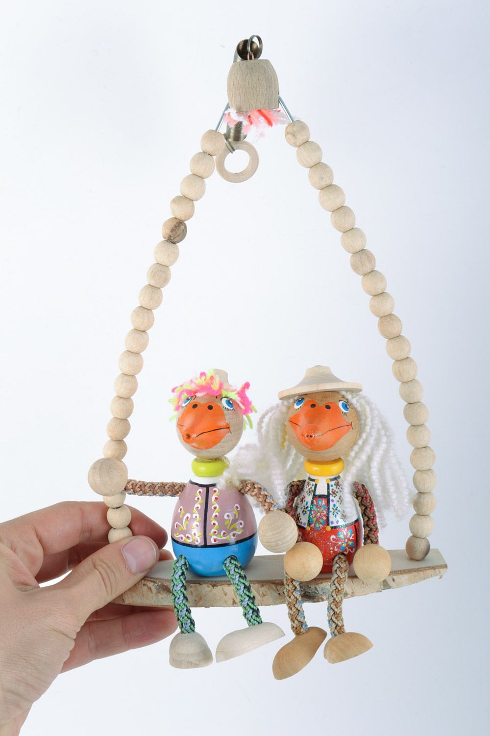Handmade painted wooden eco toys in the shape of 2 funny ducks sitting on swing photo 2
