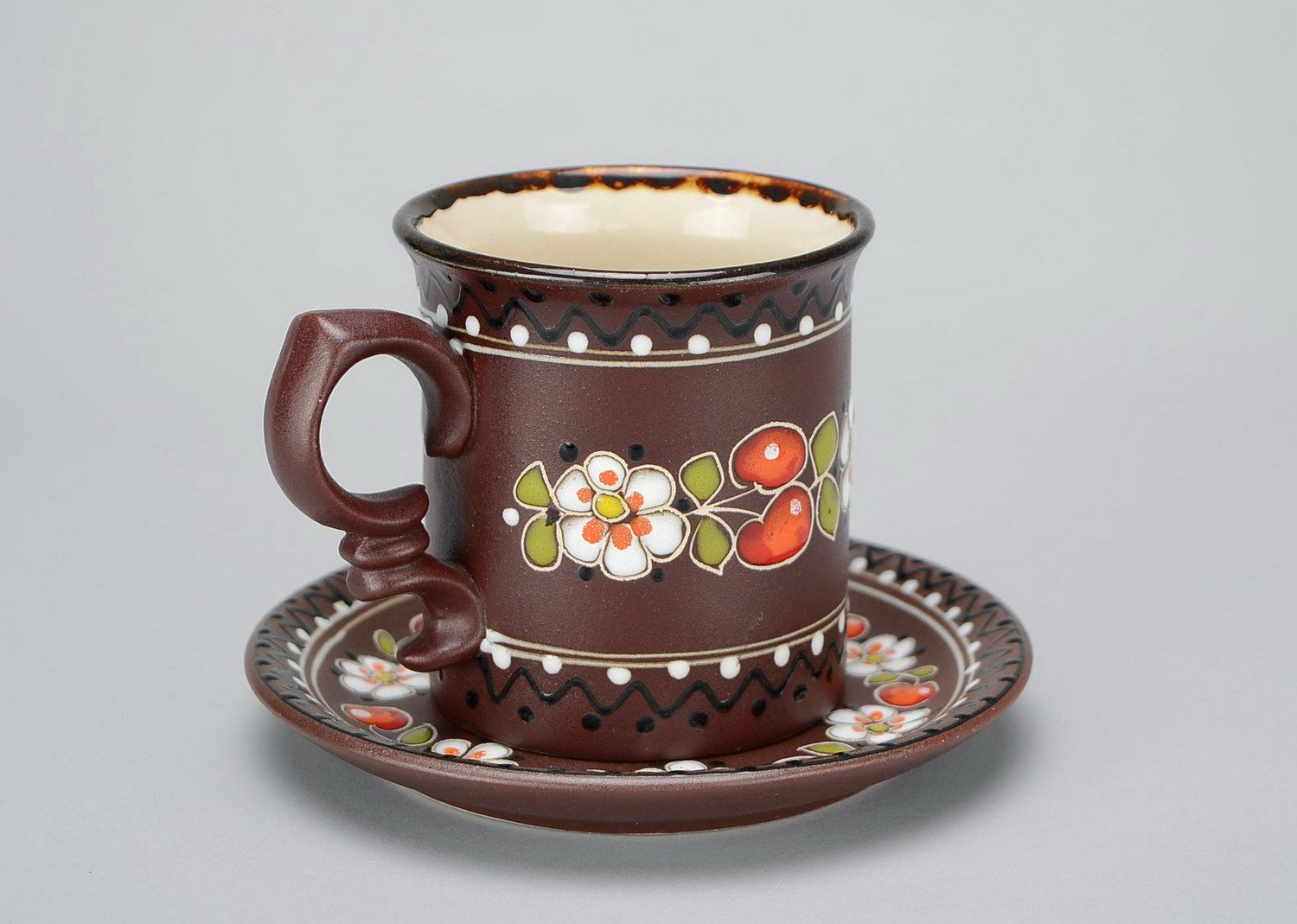 Ceramic glazed decorative brown te or coffee cup with handle, sauce and floral pattern photo 3