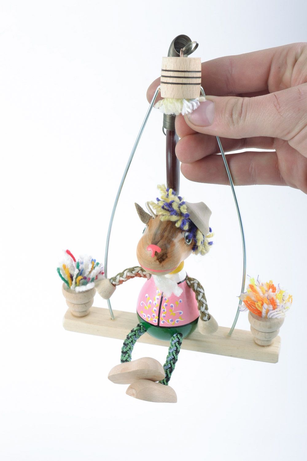 Eco friendly wooden handmade toy goat on a swing with painting funny toys for kids photo 1