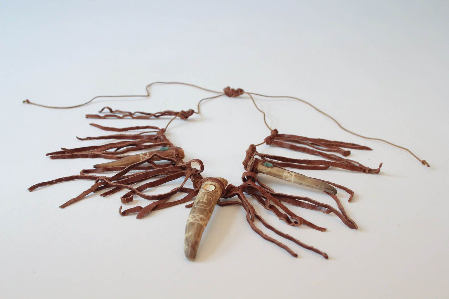 Ethnic pendant made of antler and leather photo 3
